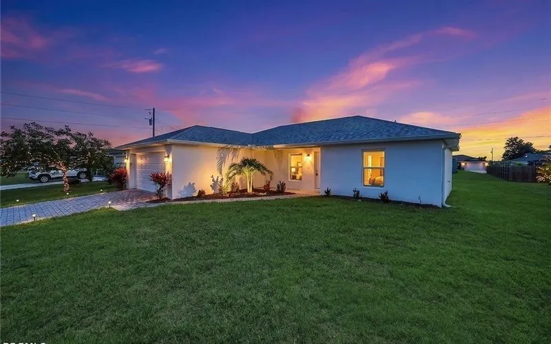 Completed single-story home at 1317 NE 9th Ave, Cape Coral, at dusk