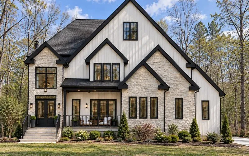 Rendering of 7656 Juniper Lane, a two-story board-and-batten and stone home with a covered front porch