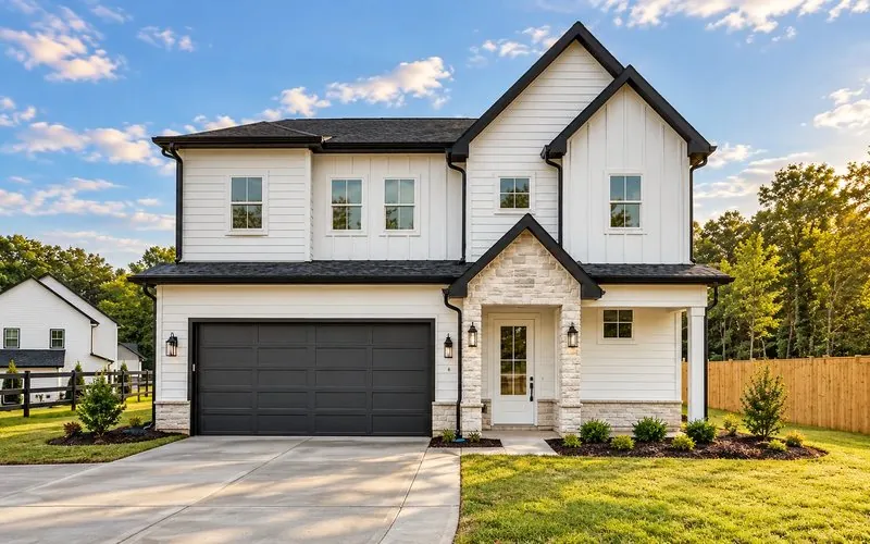 Rendering of The Willow, a two-story white farmhouse with a stone entry and two-car garage